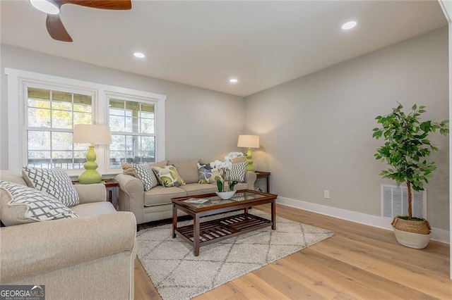 living room with hardwood / wood-style floors and ceiling fan