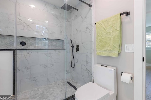 bathroom with walk in shower and toilet