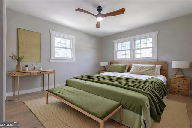 bedroom with light wood-type flooring and ceiling fan