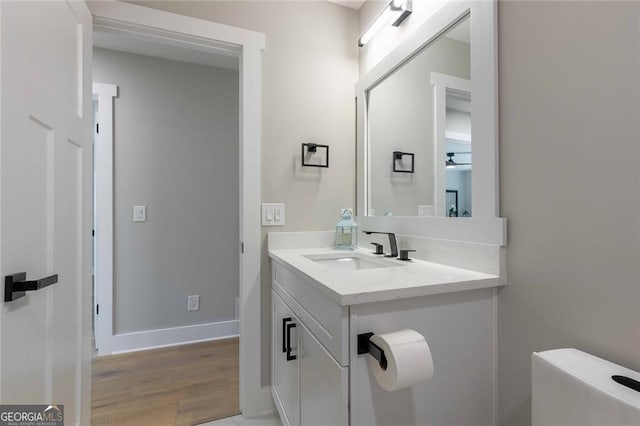 bathroom featuring ceiling fan, vanity, and toilet