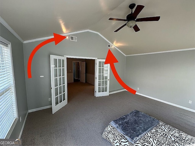 unfurnished bedroom featuring lofted ceiling, french doors, crown molding, carpet flooring, and ceiling fan