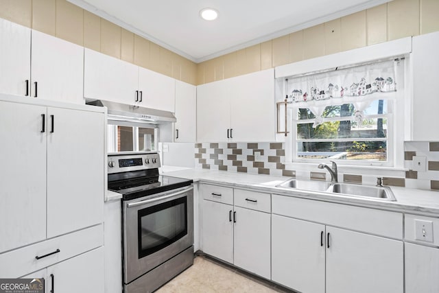 1396 Gale Dr, Norcross, GA 30093 - kitchen with stainless steel range with electric cooktop, under cabinet range hood, light countertops, ornamental molding, and backsplash