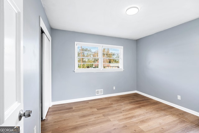 1396 Gale Dr, Norcross, GA 30093 - unfurnished bedroom with wood finished floors and a closet