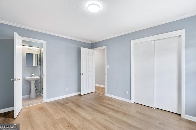 1396 Gale Dr, Norcross, GA 30093 - unfurnished bedroom featuring wood finished floors, crown molding, a closet, and ensuite bath