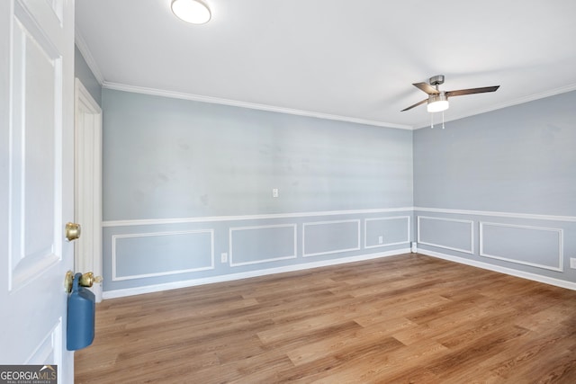 1396 Gale Dr, Norcross, GA 30093 - empty room with ceiling fan, ornamental molding, a decorative wall, wood finished floors, and a wainscoted wall