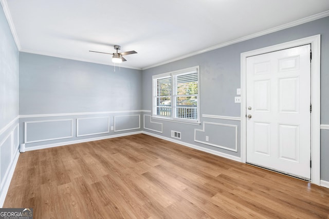 1396 Gale Dr, Norcross, GA 30093 - foyer entrance with a ceiling fan, light wood-style floors, ornamental molding, a decorative wall, and a wainscoted wall
