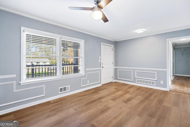 1396 Gale Dr, Norcross, GA 30093 - empty room featuring attic access, a ceiling fan, ornamental molding, wood finished floors, and wainscoting
