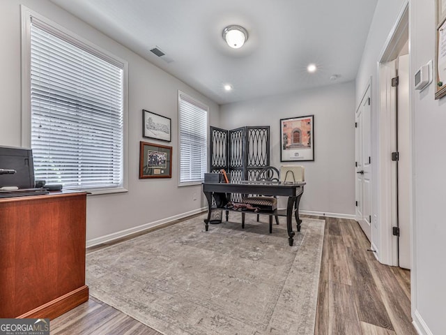 office area with hardwood / wood-style floors and a healthy amount of sunlight