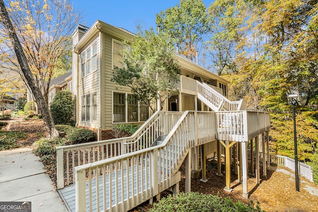 rear view of property with a wooden deck