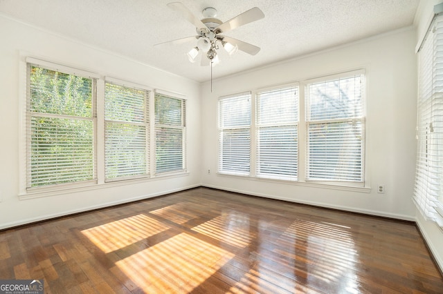 unfurnished sunroom featuring a wealth of natural light and ceiling fan