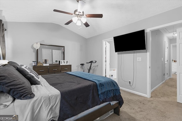 bedroom featuring connected bathroom, ceiling fan, light carpet, and lofted ceiling