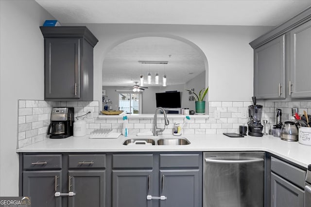 kitchen with decorative backsplash, gray cabinetry, ceiling fan, sink, and dishwasher