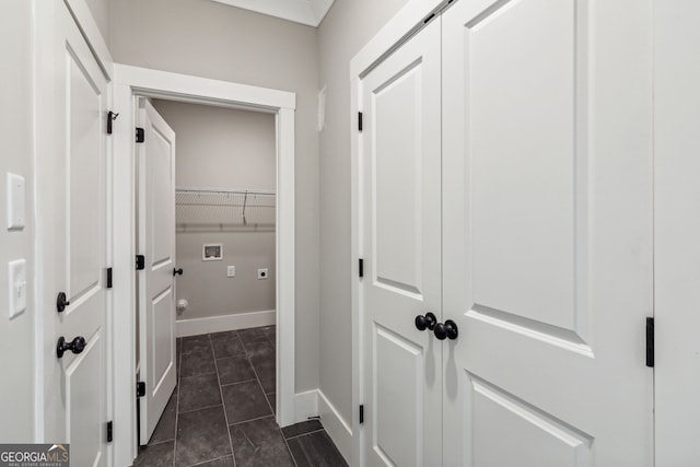 hallway featuring dark tile patterned floors