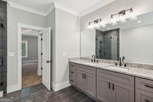 bathroom with crown molding, vanity, and an enclosed shower