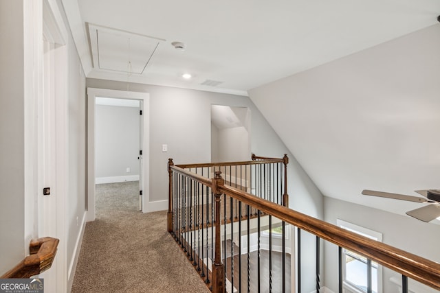 hall featuring carpet and vaulted ceiling