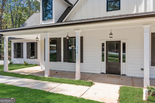 view of exterior entry featuring a porch