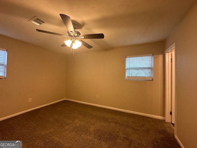 carpeted spare room with a textured ceiling and ceiling fan