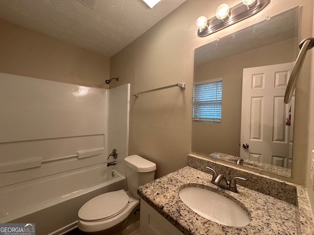 full bathroom featuring vanity,  shower combination, toilet, and a textured ceiling