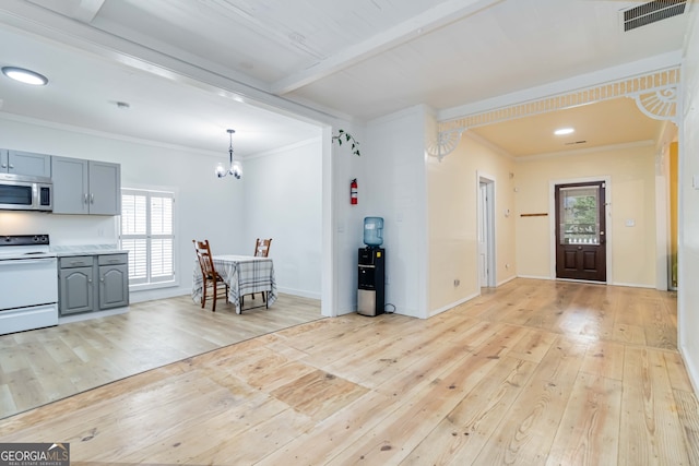 entrance foyer featuring beam ceiling, crown molding, and light hardwood / wood-style flooring