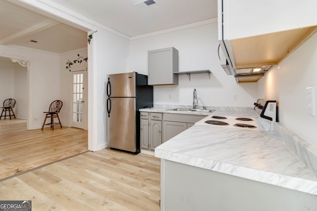 kitchen with gray cabinets, stainless steel fridge, white electric stove, and light hardwood / wood-style flooring