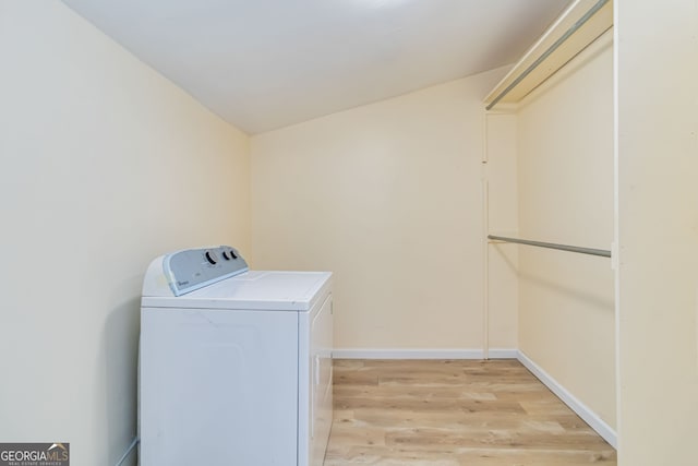 clothes washing area featuring washer / dryer and light wood-type flooring