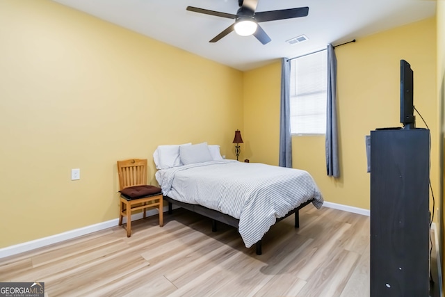 bedroom with ceiling fan and light wood-type flooring