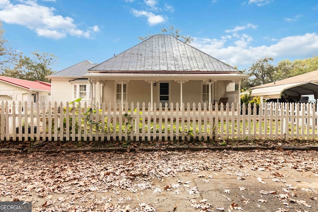 rear view of property with covered porch