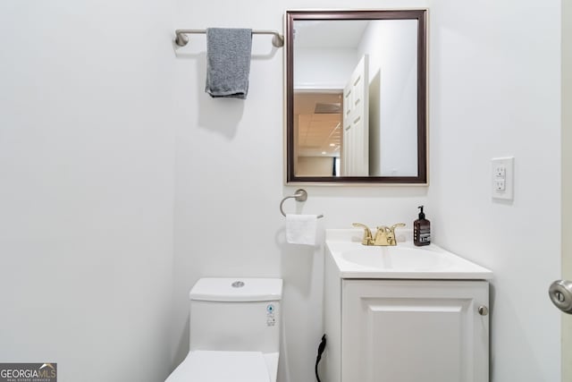 bathroom featuring vanity and toilet