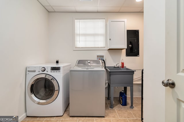 clothes washing area featuring sink, cabinets, separate washer and dryer, electric panel, and light tile patterned flooring