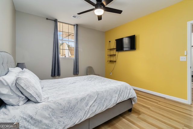 bedroom with hardwood / wood-style floors and ceiling fan