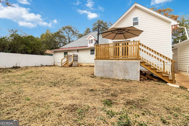 rear view of house with a wooden deck