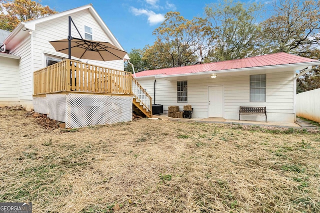 back of property with central air condition unit and a wooden deck