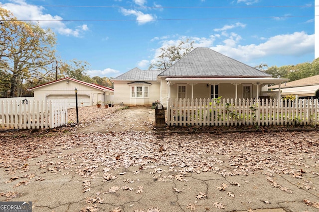 rear view of house featuring an outbuilding and a garage