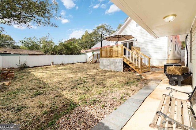 view of yard featuring a deck and central air condition unit