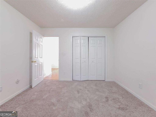 334 Royal Crescent Way, Stockbridge, GA 30281 - unfurnished bedroom with a textured ceiling, carpet, a closet, and baseboards