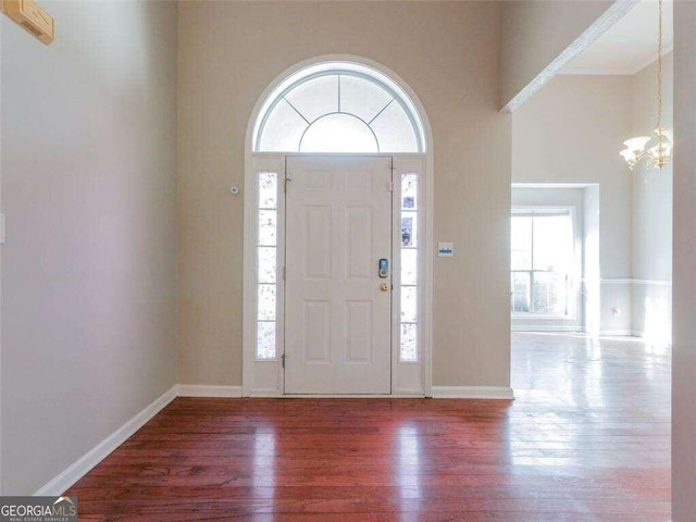 334 Royal Crescent Way, Stockbridge, GA 30281 - entryway with a chandelier, wood finished floors, baseboards, and a towering ceiling
