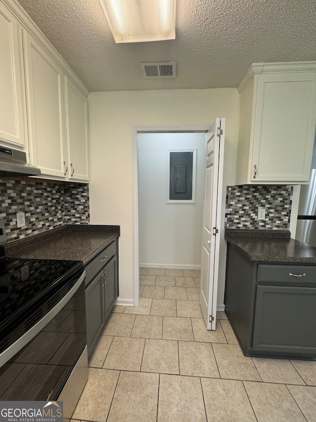 kitchen with white cabinets, tasteful backsplash, and stainless steel range with electric stovetop