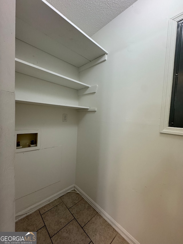 clothes washing area featuring washer hookup and tile patterned floors