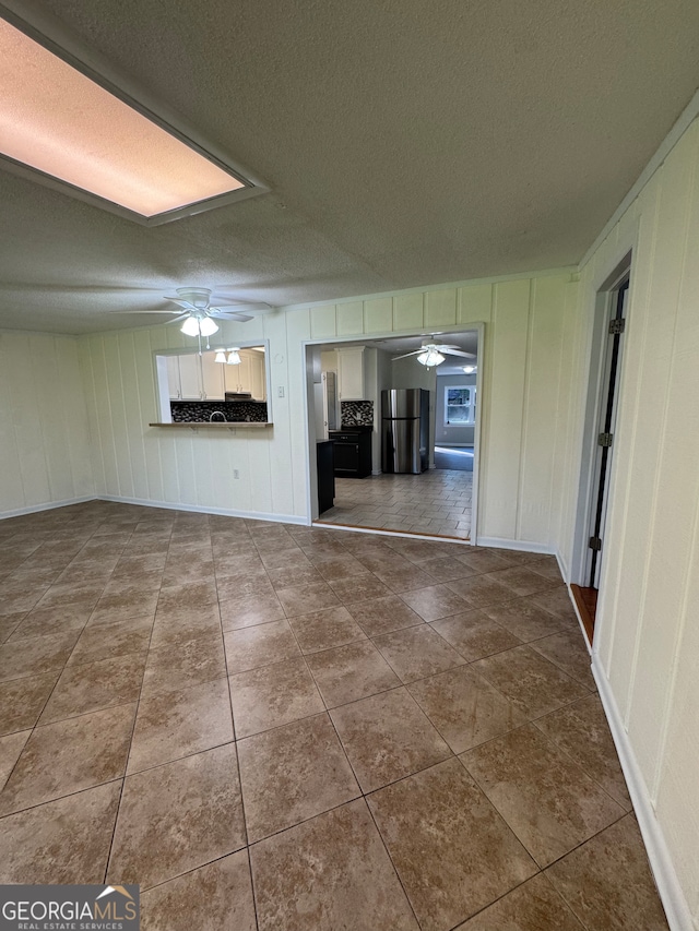 unfurnished living room featuring a textured ceiling