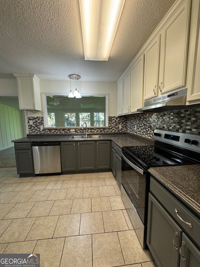 kitchen with backsplash, white cabinetry, sink, and appliances with stainless steel finishes