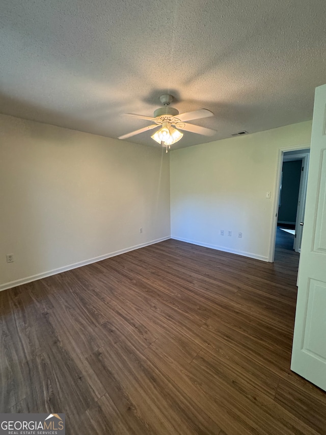 unfurnished room featuring a textured ceiling, dark hardwood / wood-style flooring, and ceiling fan