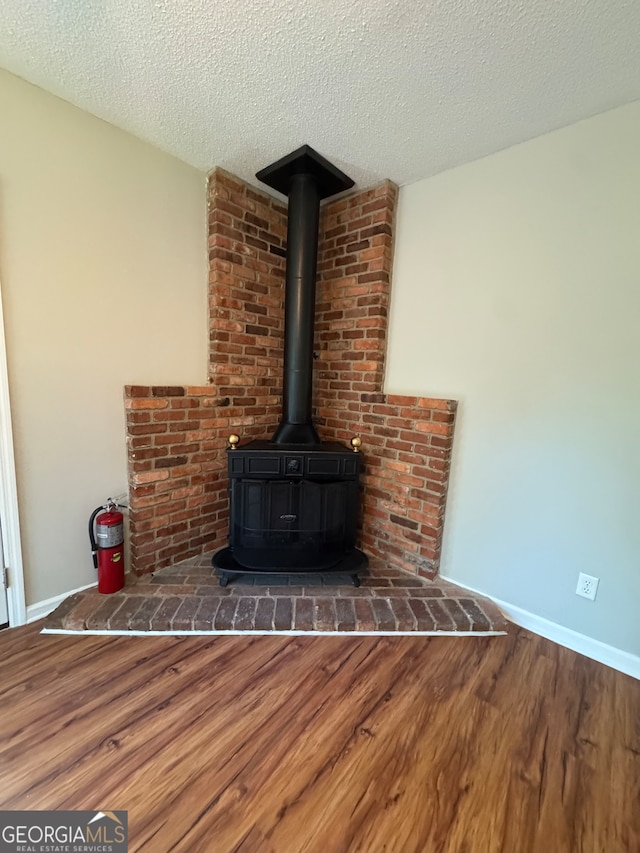 details featuring a textured ceiling and hardwood / wood-style flooring