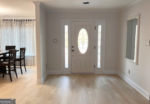 entrance foyer featuring crown molding and light wood-type flooring