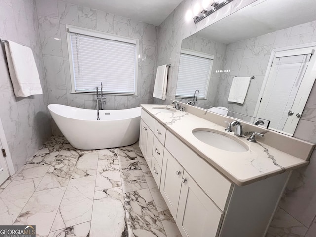 bathroom with a washtub, vanity, and tile walls