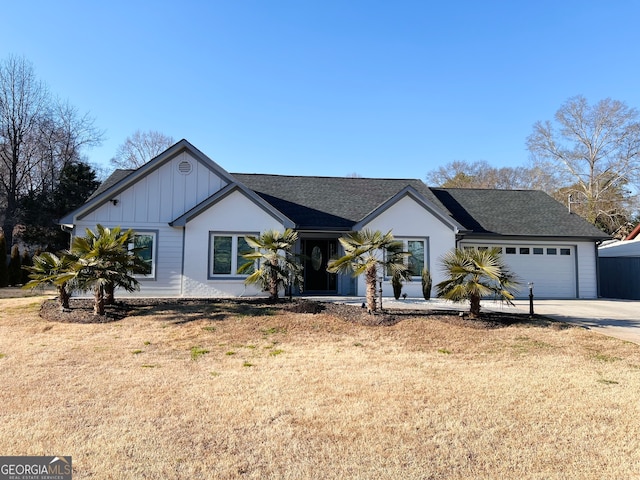 ranch-style house featuring a front lawn and a garage