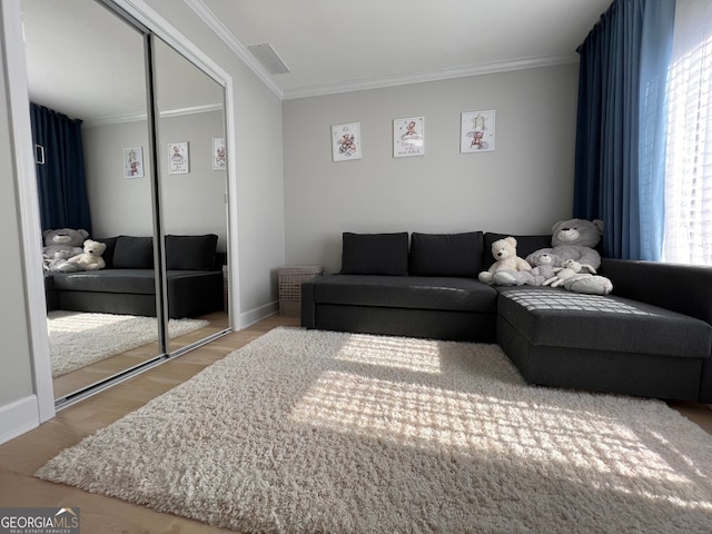 living room featuring hardwood / wood-style floors and ornamental molding