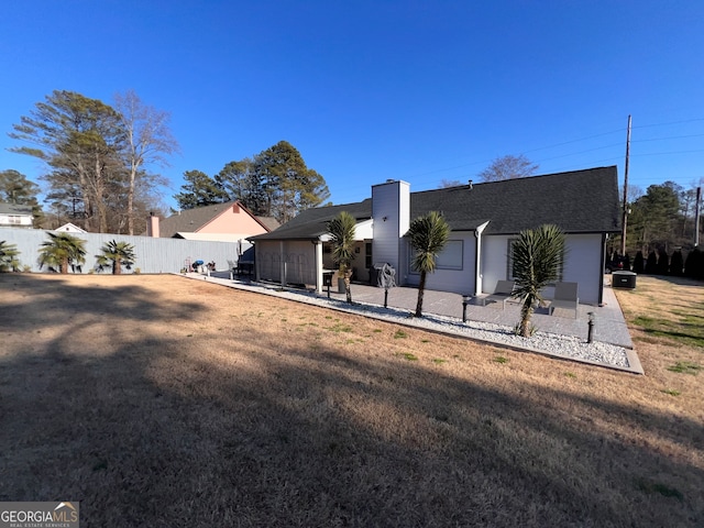 back of house with a patio, cooling unit, and a lawn