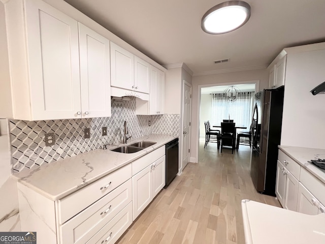 kitchen with white cabinets, sink, light wood-type flooring, black dishwasher, and stainless steel refrigerator