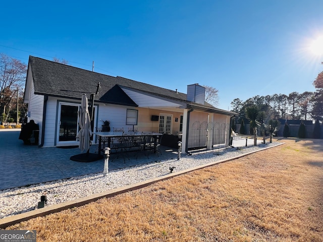 back of property with a patio