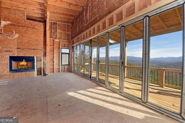 unfurnished sunroom with a mountain view and a fireplace